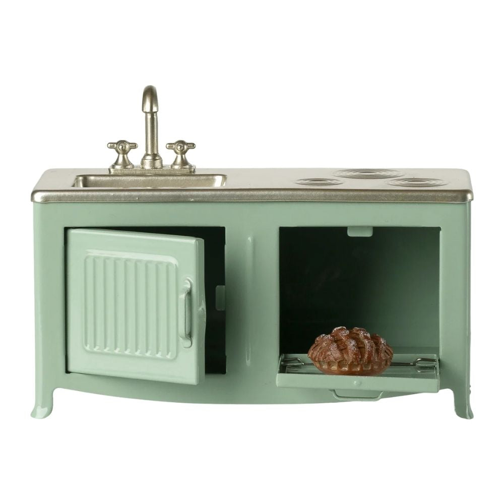 Vintage-style kitchen sink with stove and oven on a white background