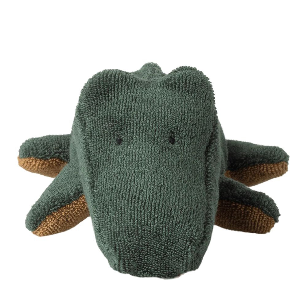 Knitted dinosaur toy with a green body and brown legs on a white background