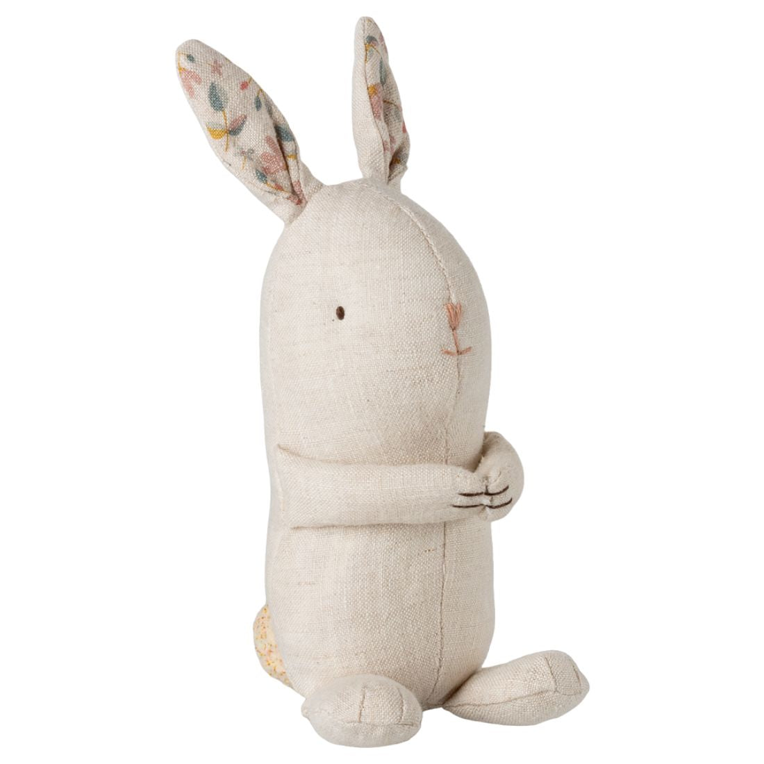 Stuffed rabbit toy with floral ears on a white background