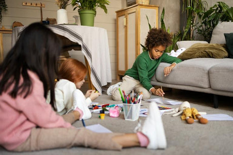 Children colouring while sitting on the floor