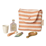 Striped pouch with small accessories on a white background