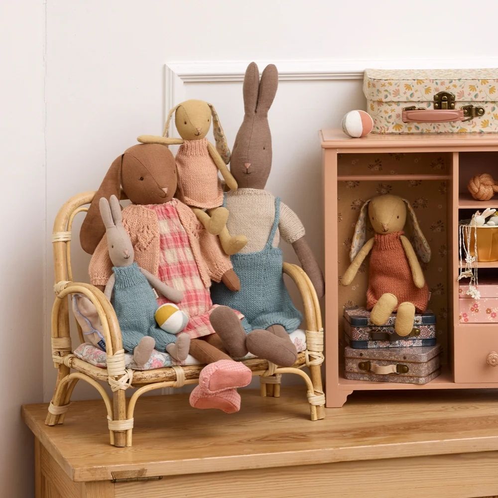 Set of plush toys in a room with a chair and shelves.