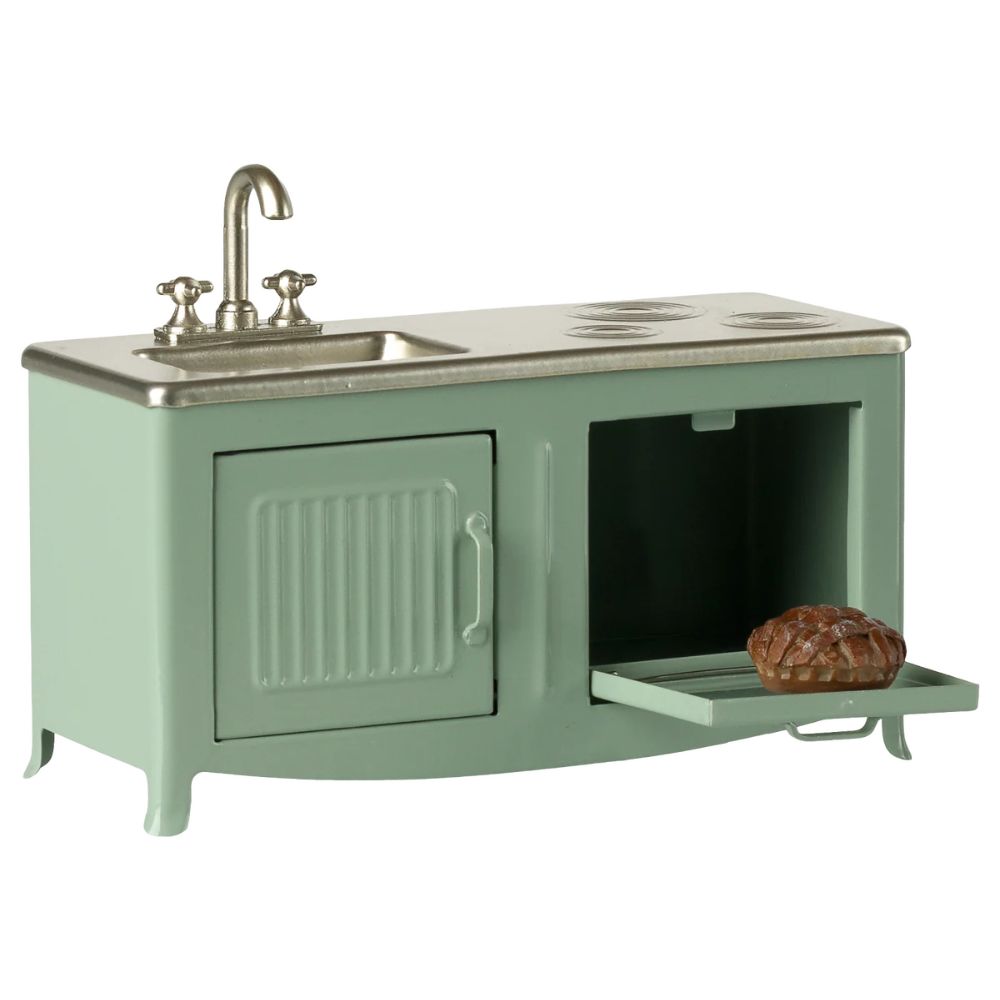 Green play kitchen set with sink and stove on a white background