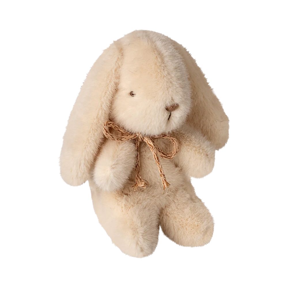Beige plush bunny with a brown bow on a white background