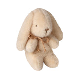 Beige plush bunny with a brown bow on a white background