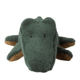 Knitted dinosaur toy with a green body and brown legs on a white background