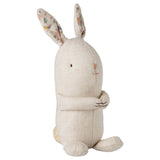 Stuffed rabbit toy with floral ears on a white background