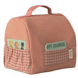 Pink pet journal with a handle and pockets on a white background
