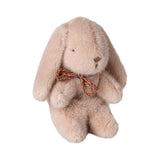 Plush bunny toy with a gold bow on a white background