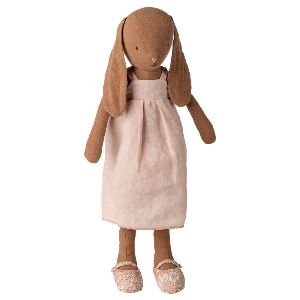 Stuffed rabbit doll with a pink dress on a white background
