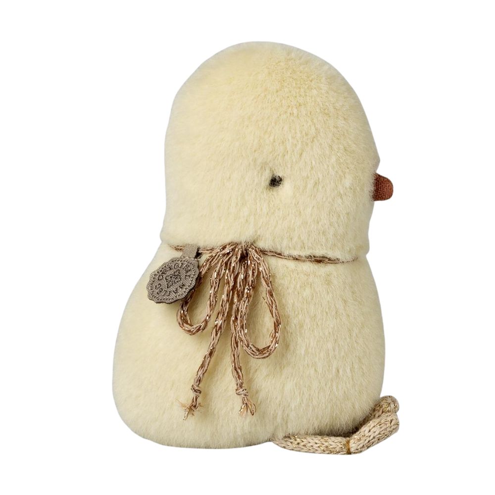 Plush toy resembling a bird with a tag on a white background