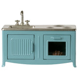 Teal stove with sink on a white background